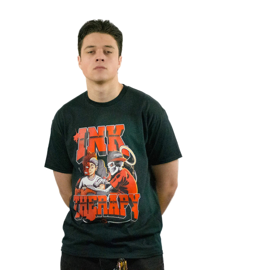 Model wearing black Ink Therapy graphic T-shirt featuring illustrated tattoo artwork in red and white
