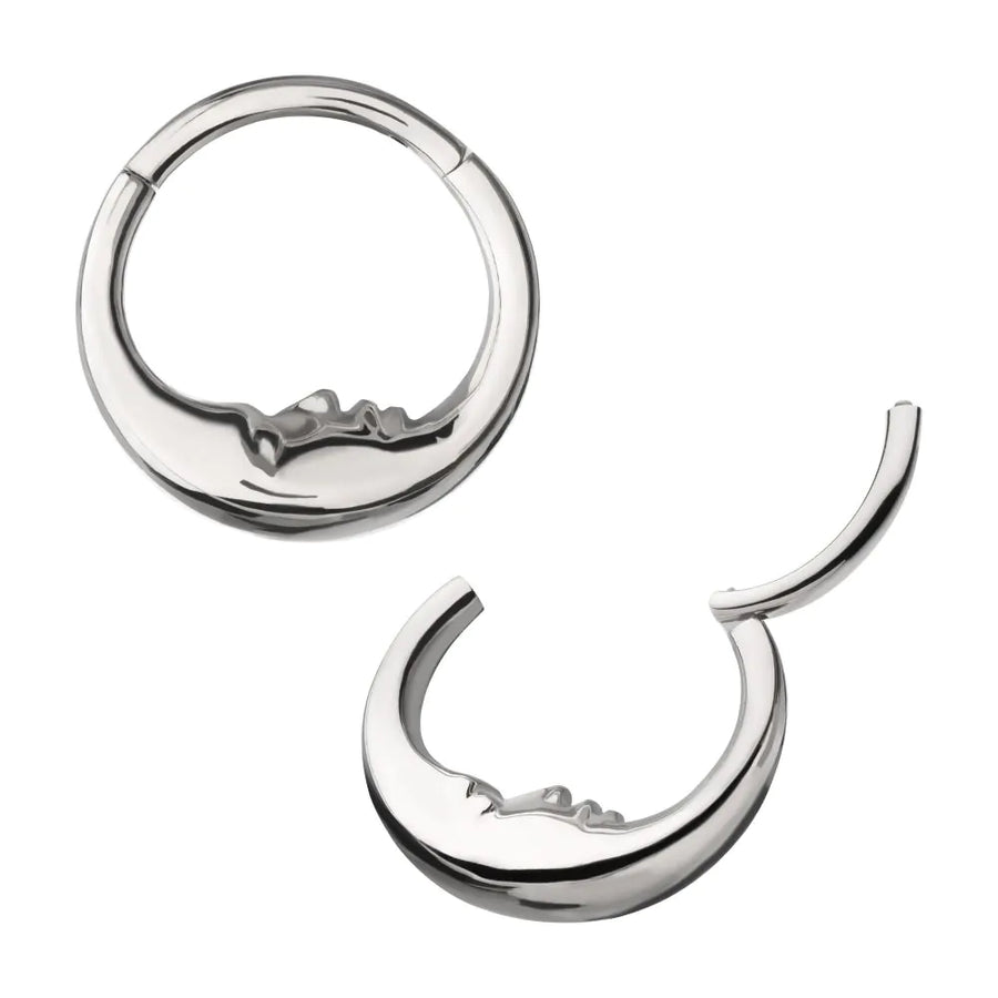 A polished silver or titanium celestial-themed septum clicker jewelry piece, featuring a crescent moon with a detailed, sleeping "Man in the Moon" face along the inner curve, shown in both closed and open hinged positions.
