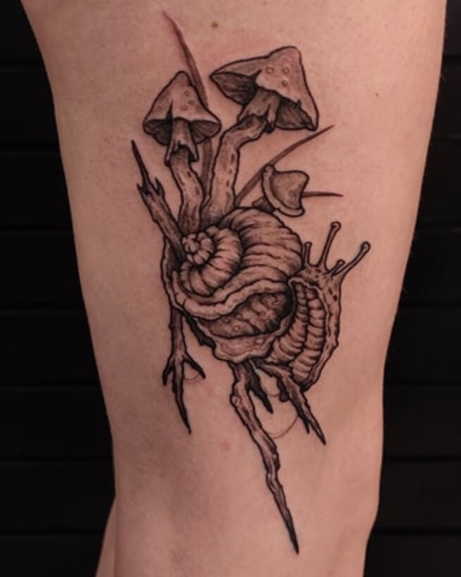 Tattoo of mushrooms on a person's arm with a dark background