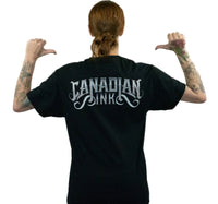 Model wearing black Ink Therapy graphic T-shirt featuring Canadian Ink logo artwork on back