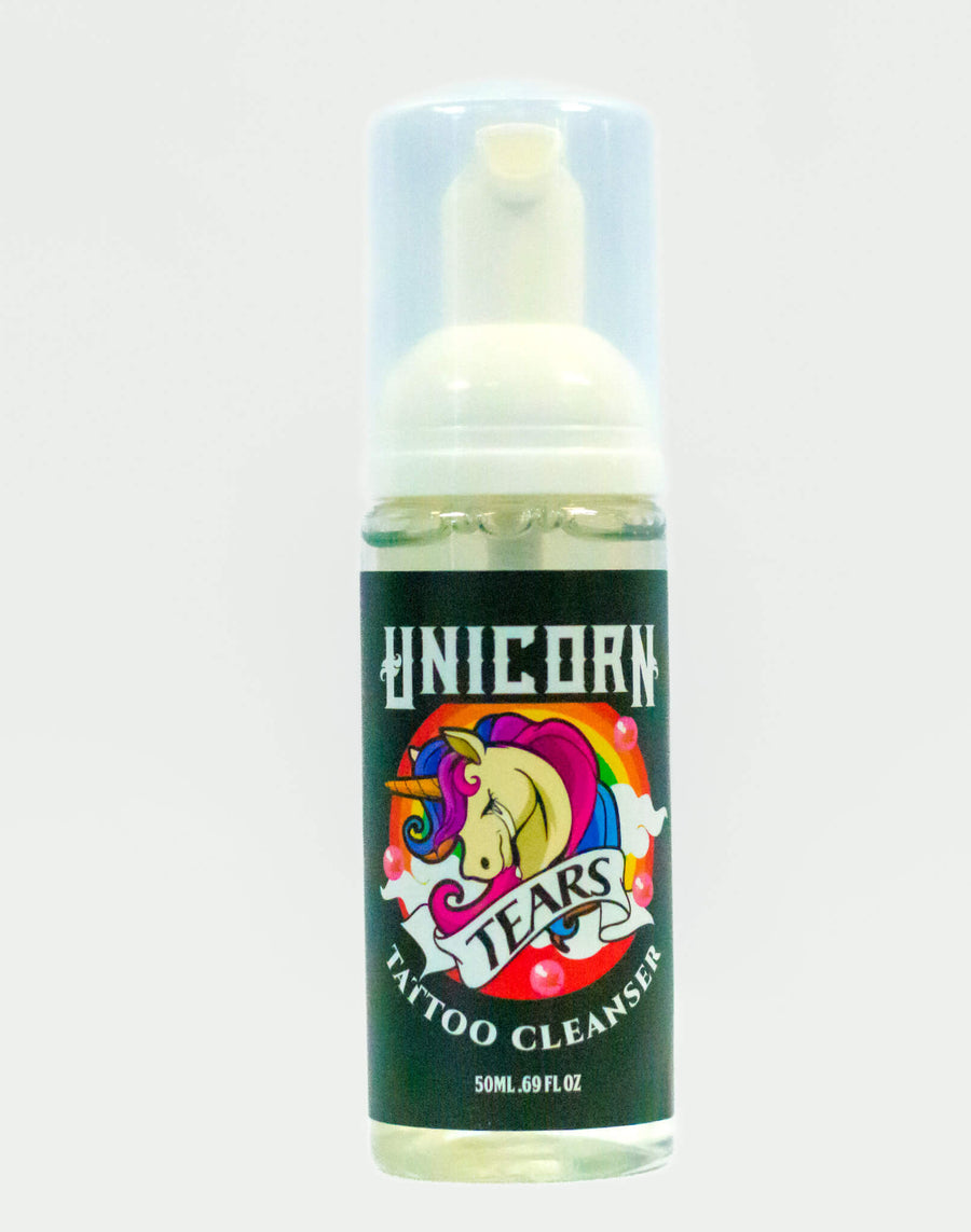 Bottle of Unicorn Tears Tattoo Cleanser with colorful design on a white background