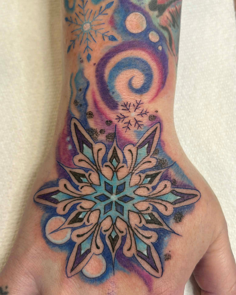 Colorful mandala tattoo on a hand with a white background