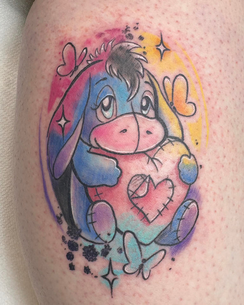 Colorful tattoo of a cartoon character with a heart on skin