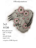 Hawk tattoo design with extended wings surrounded by soft pink flowers