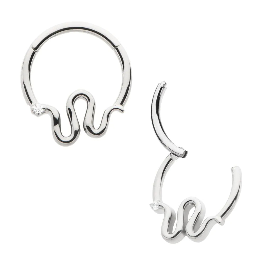 A polished silver or titanium hinged septum clicker jewelry piece, featuring a unique wavy, serpentine-style design along the bottom curve with a single, small clear crystal accent on one side, shown in both closed and open positions.