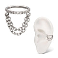 A high-quality silver or titanium hinged clicker jewelry piece featuring a top band set with a row of clear pavé crystals and two draped cable chains of differing lengths hanging below, shown as a standalone item and modeled on a white silicone ear display.